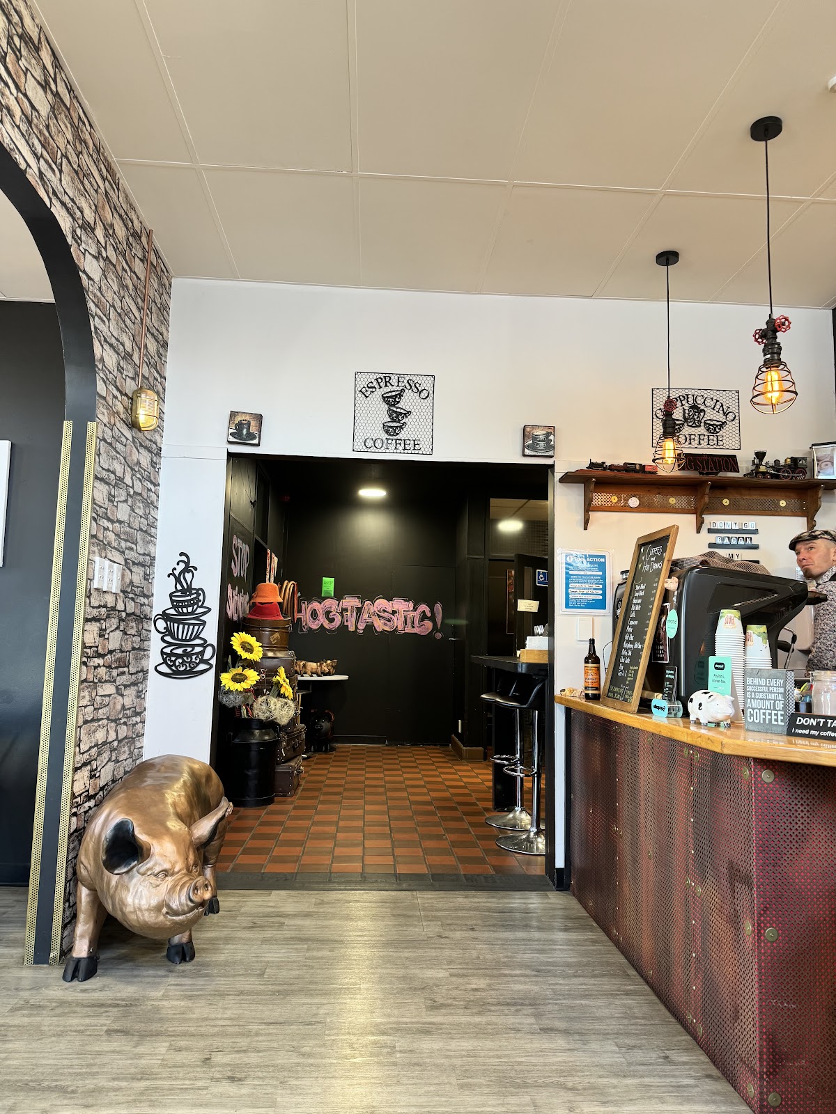 Inside The Pig Station with the brass pig statue and Hogtastic chalk art